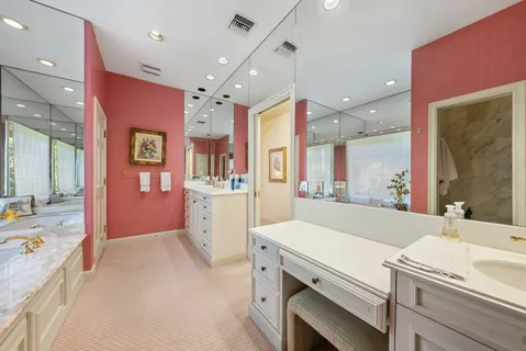 a large white kitchen with a large window