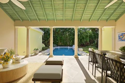 a view of a patio with table and chairs and potted plants