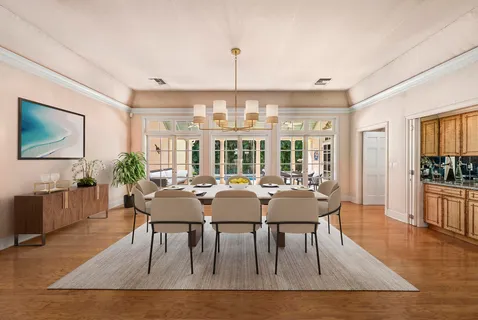 a view of a dining room with furniture window and wooden floor