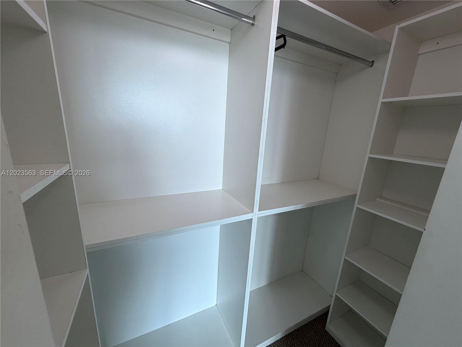 2021 Southwest 3rd Avenue, Unit 902 Miami, FL 33129 - Photo 10 of 14 a view of walk in closet with empty racks