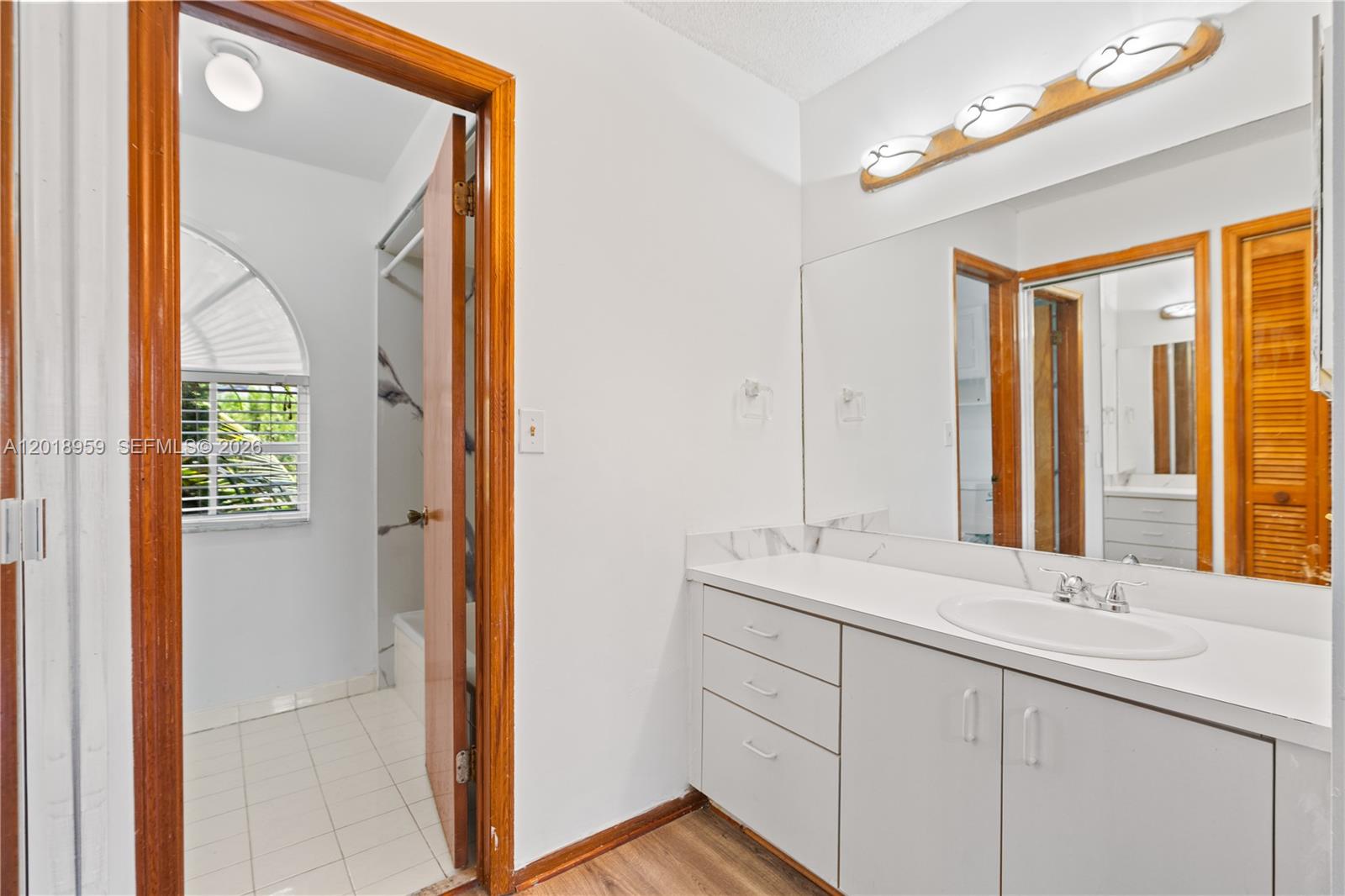 15345 Southwest 63rd Terrace Miami, FL 33193 - Photo 11 of 51 a en suite bathroom with a sink mirror and a shower