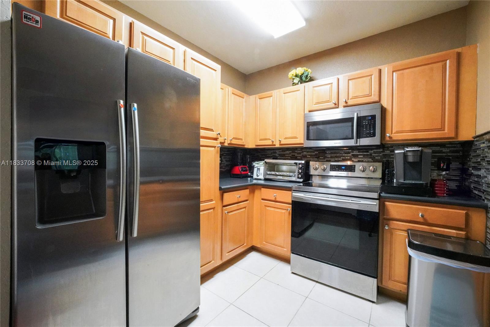 3335 Palomino Drive Davie, FL 33024 - Photo 14 of 31 a kitchen with stainless steel appliances granite countertop a refrigerator and a stove top oven