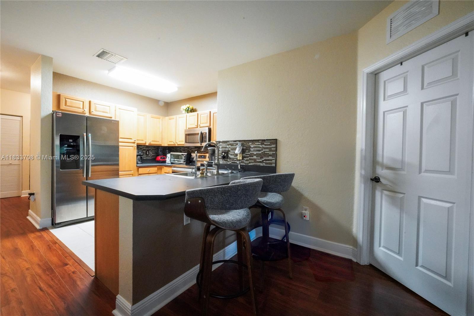 3335 Palomino Drive Davie, FL 33024 - Photo 15 of 31 a kitchen with stainless steel appliances granite countertop a sink and a refrigerator