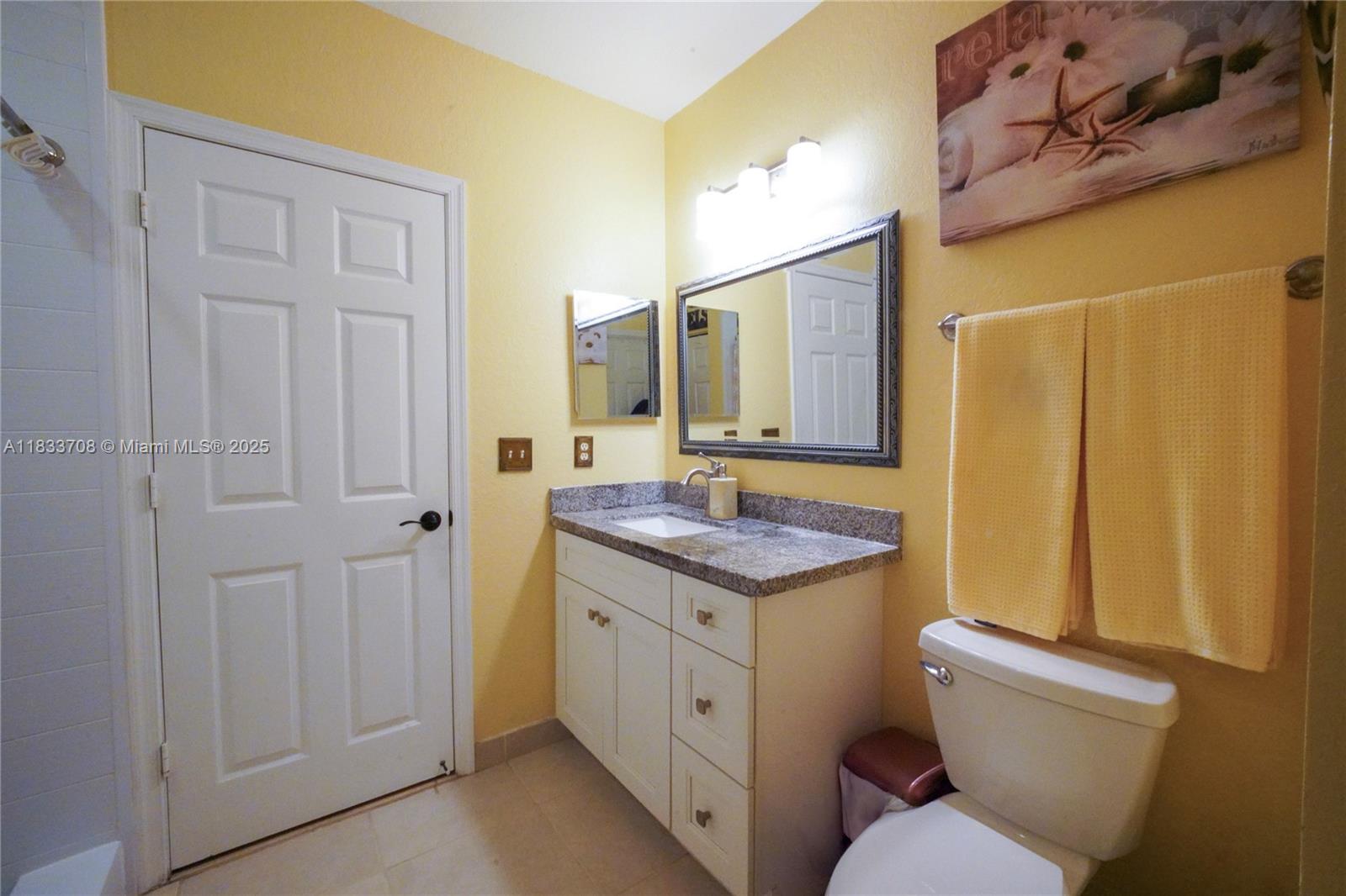 3335 Palomino Drive Davie, FL 33024 - Photo 20 of 31 a spacious bathroom with a granite countertop sink and a mirror