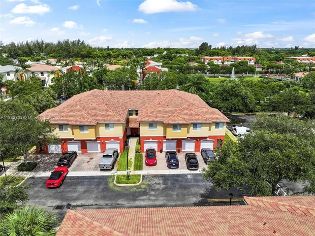 an aerial view of a house with garden space and street view