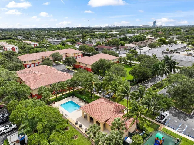 an aerial view of lake and residential houses with outdoor space