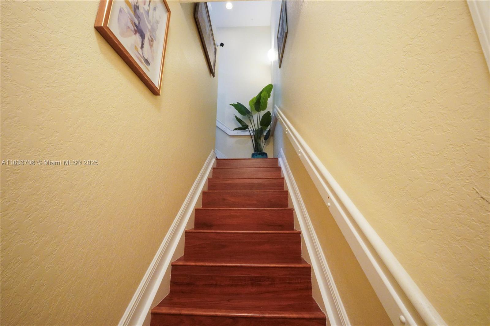 3335 Palomino Drive Davie, FL 33024 - Photo 5 of 31 a view of a hallway with wooden floor and stairs