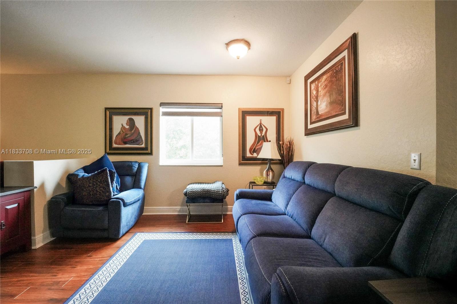 3335 Palomino Drive Davie, FL 33024 - Photo 9 of 31 a living room with furniture and a flat screen tv