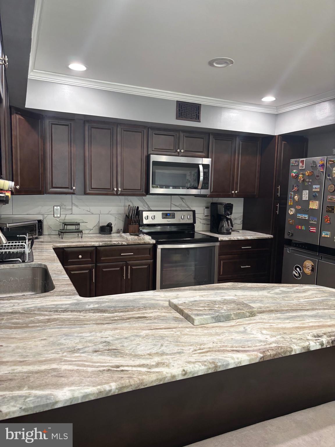 60 High Meadows Drive Sicklerville, NJ 08081 - Photo 20 of 60 a kitchen with kitchen island granite countertop a stove sink and cabinets