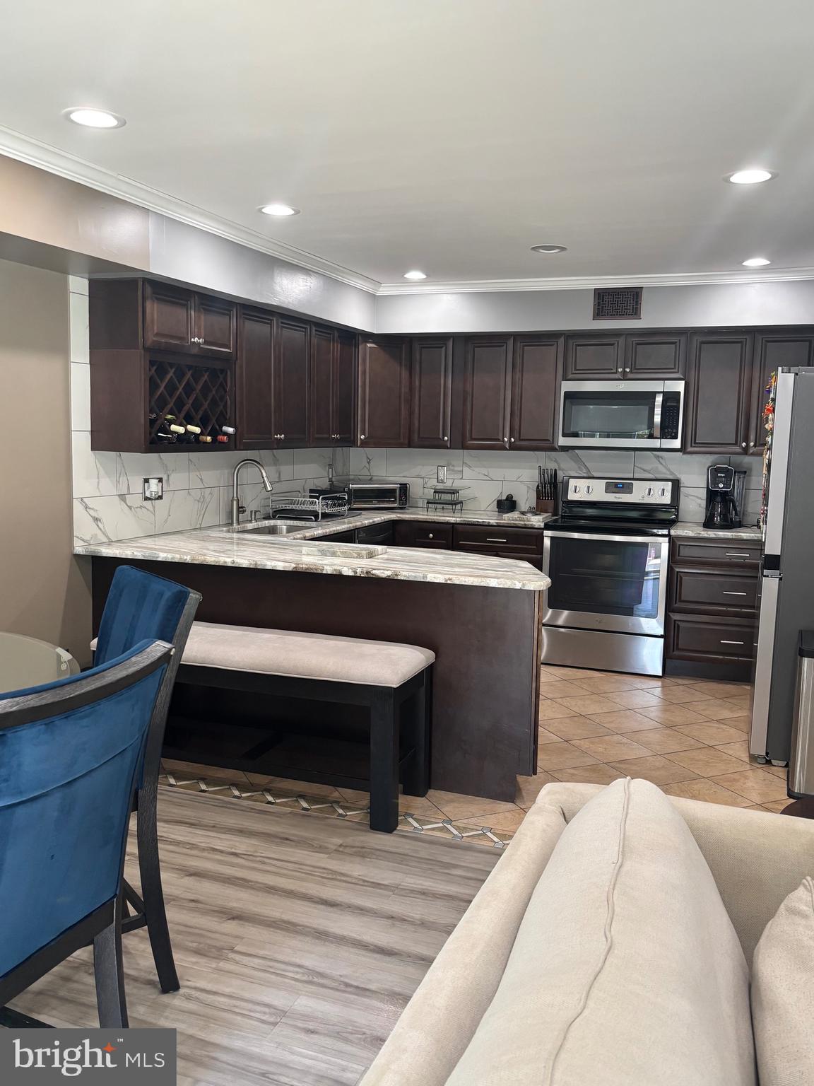60 High Meadows Drive Sicklerville, NJ 08081 - Photo 26 of 60 a kitchen with stainless steel appliances kitchen island granite countertop a sink dishwasher a stove and a refrigerator with wooden floor