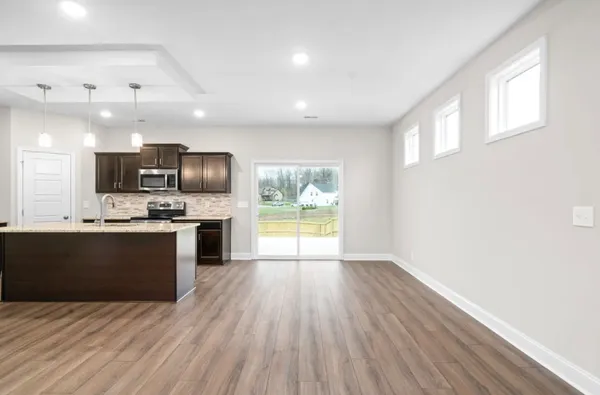 a view of kitchen with sink microwave refrigerator and stove