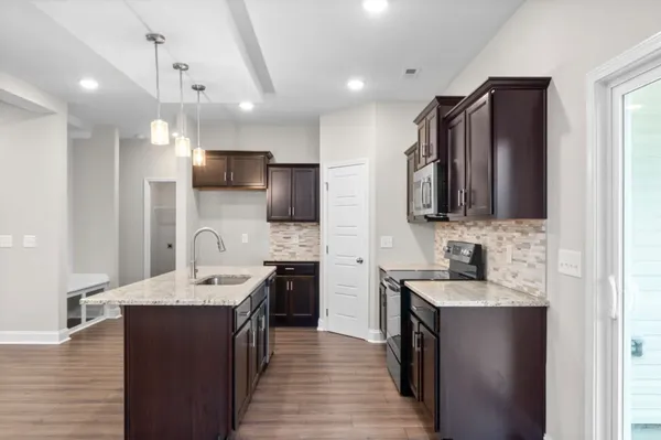 a kitchen with stainless steel appliances a sink stove and refrigerator