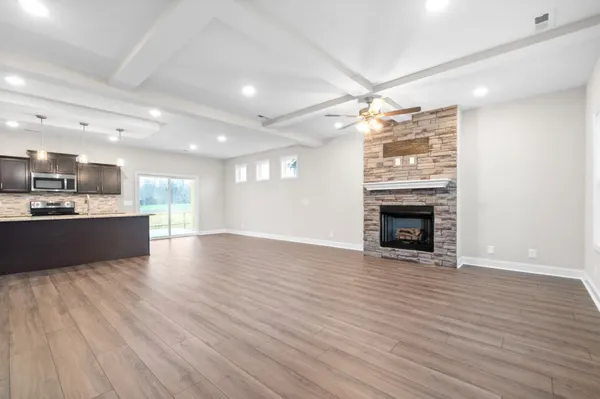 a view of kitchen with granite countertop cabinets and wooden floor