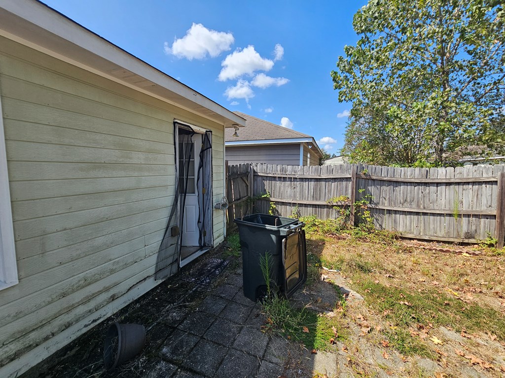 65 Ryan Loop Phenix City, AL 36869 - Photo 17 of 18 a view of a house with a wooden fence