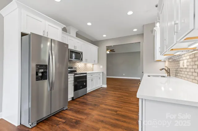 a kitchen with stainless steel appliances a refrigerator and a sink