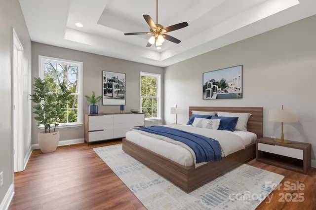 a spacious bedroom with a large bed chandelier and a window