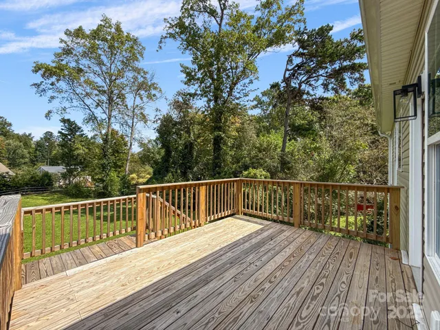 a view of balcony with wooden floor and fence