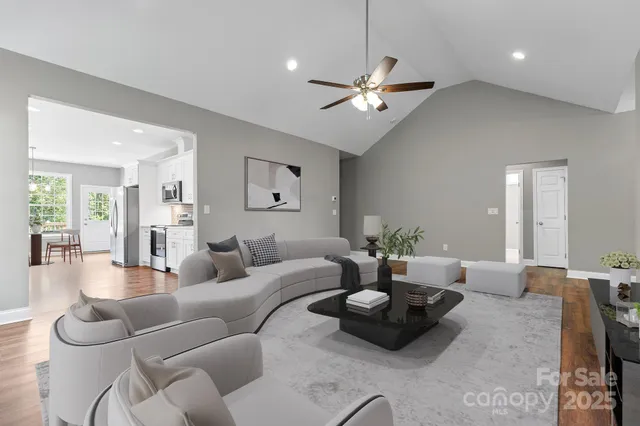a living room with furniture and a chandelier