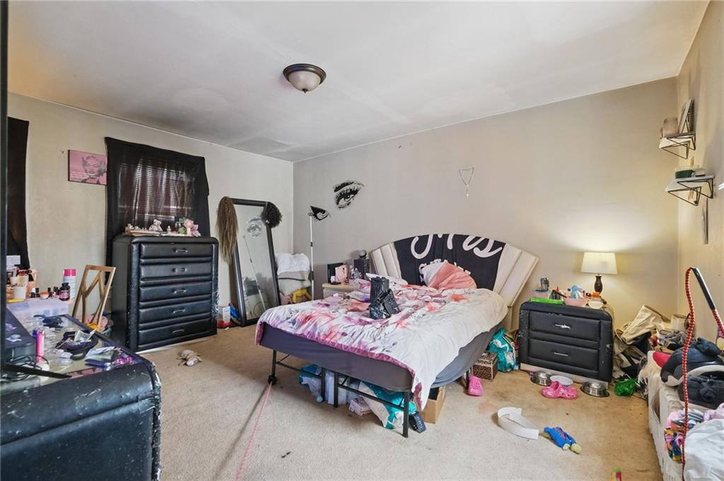 853 Railroad Street McKees Rocks, PA 15136 - Photo 9 of 19 a bedroom with bed and a chandelier