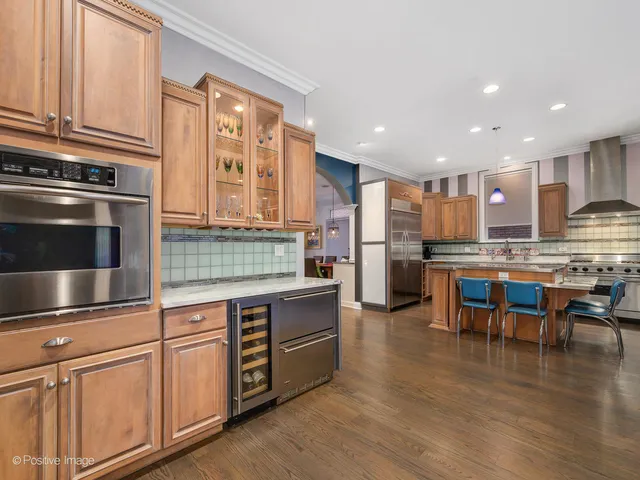 a kitchen with stainless steel appliances granite countertop a stove and a refrigerator