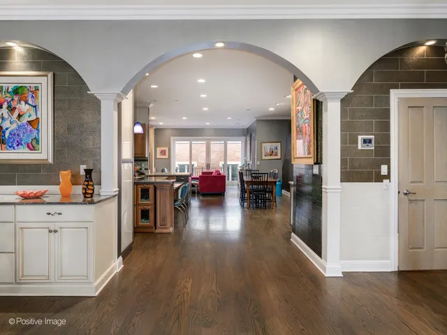 a open kitchen with furniture and wooden floor
