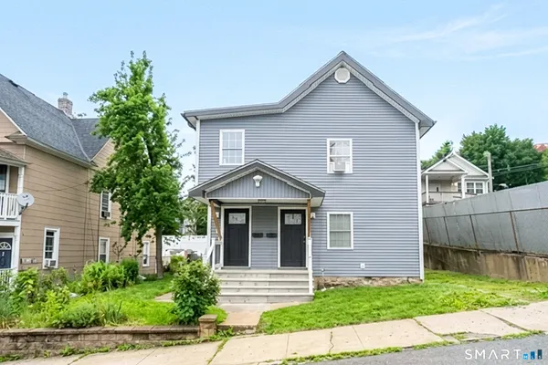 a front view of a house with a yard