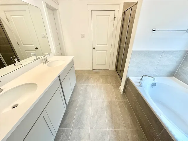 a bathroom with a tub sink and mirror