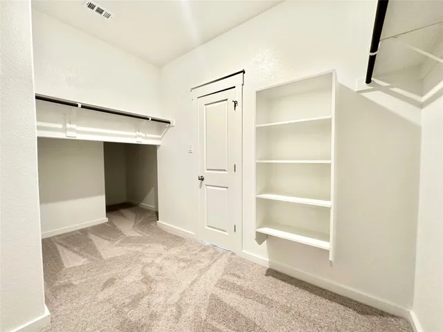 a view of an empty room with a closet