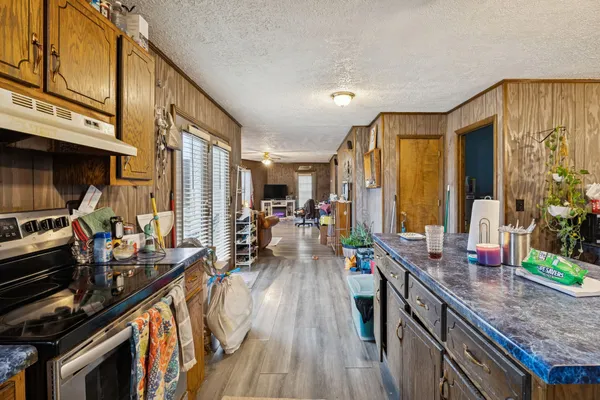 a kitchen with lots of counter top space and wooden floor