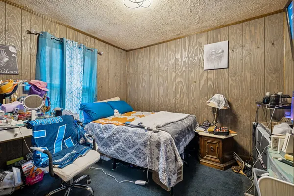 a bedroom with bed and a window
