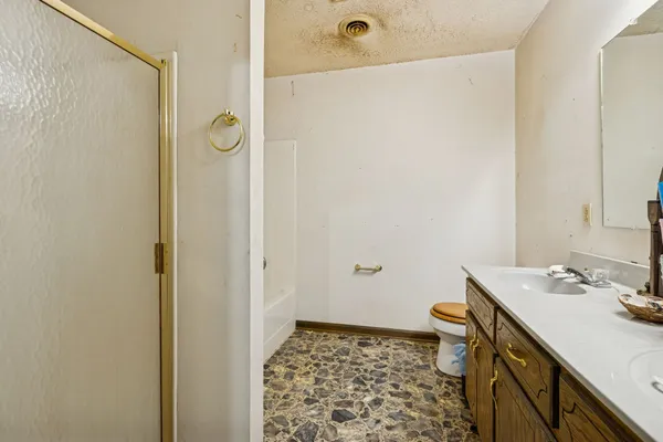 a bathroom with a sink toilet and shower