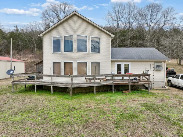 a view of a house with a yard and sitting area