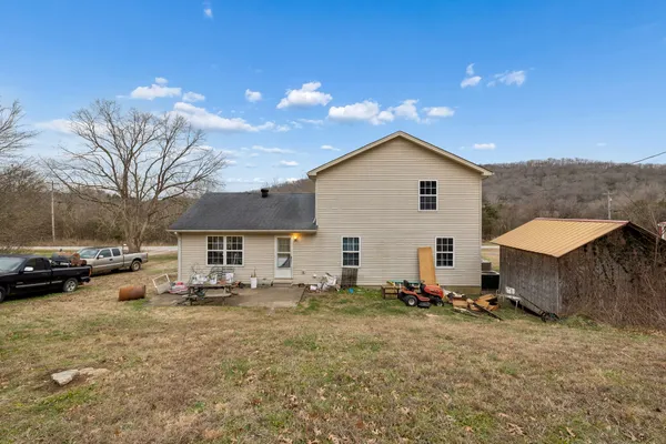 a view of a house with a yard and sitting area