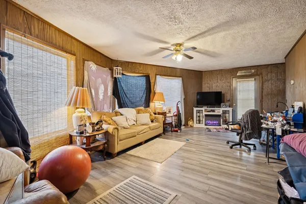 a living room with furniture a flat screen tv and a fireplace