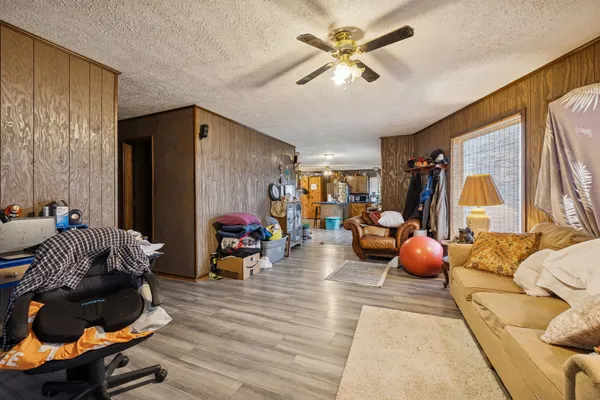 a living room with furniture and a chandelier