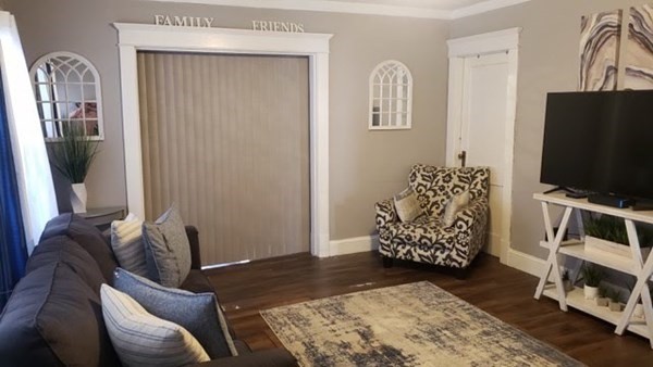 24-26 Wait Street Springfield, MA 01104 - Photo 11 of 15 a living room with furniture and a flat screen tv