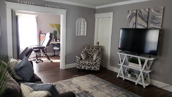 24-26 Wait Street Springfield, MA 01104 - Photo 12 of 15 a living room with furniture and a flat screen tv