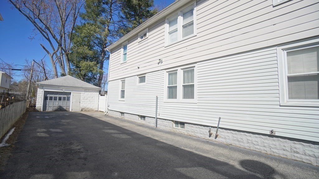24-26 Wait Street Springfield, MA 01104 - Photo 14 of 15 a view of a white house with a yard and garage
