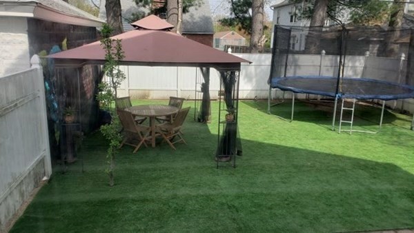 24-26 Wait Street Springfield, MA 01104 - Photo 15 of 15 a backyard of a house with table and chairs