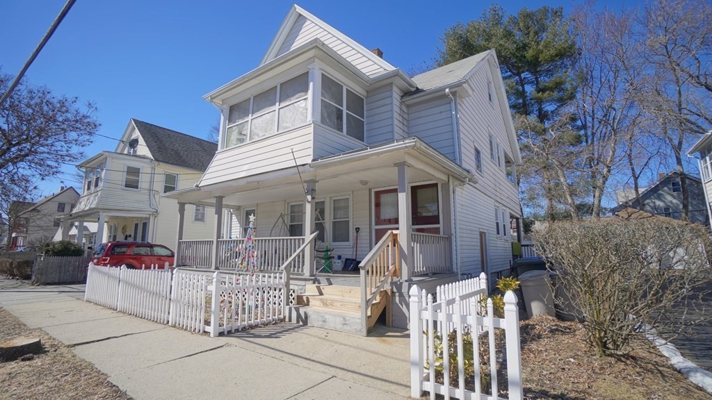 24-26 Wait Street Springfield, MA 01104 - Photo 3 of 15 a view of a white house with large windows and table and chairs