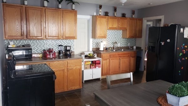 24-26 Wait Street Springfield, MA 01104 - Photo 7 of 15 a kitchen with stainless steel appliances granite countertop a refrigerator a sink dishwasher a stove and white cabinets