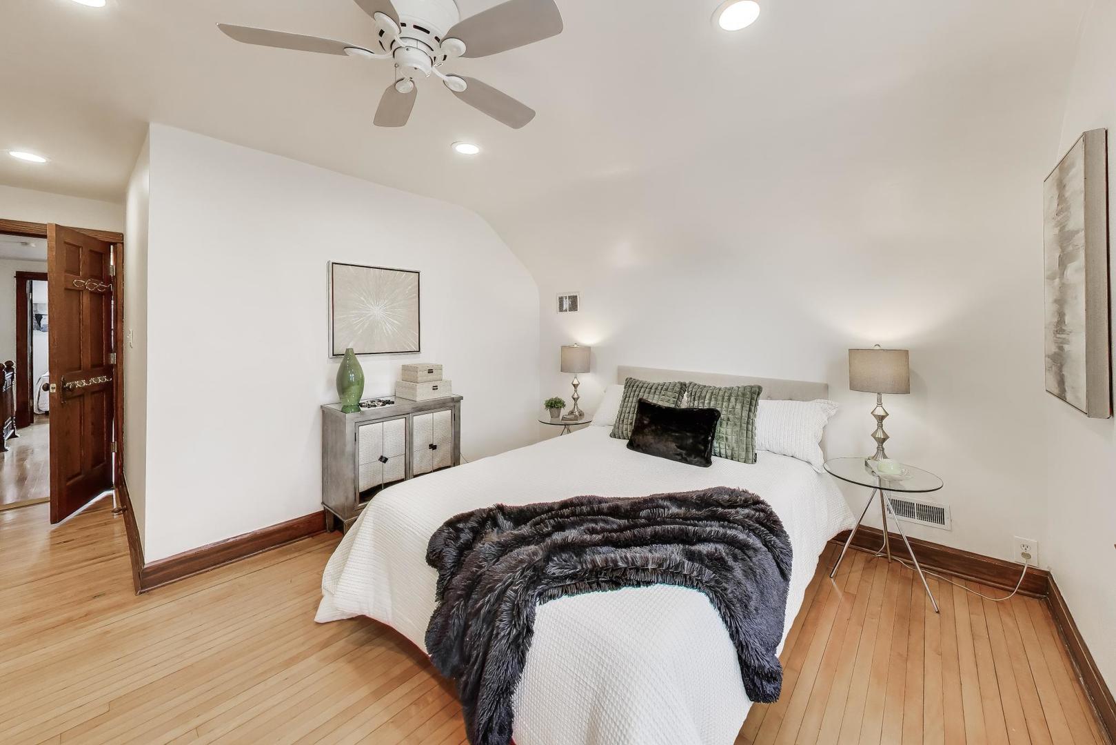 256 Blackhawk Road Riverside, IL 60546 - Photo 27 of 73 a bedroom with a bed and wooden floor