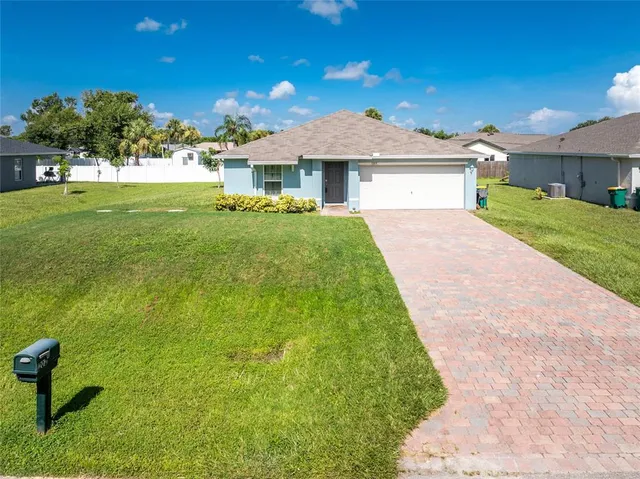 a front view of a house with a yard and porch