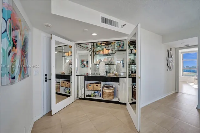 a view of a dining room with furniture a chandelier and wooden floor