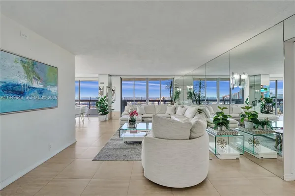 a dining room with furniture and a floor to ceiling window