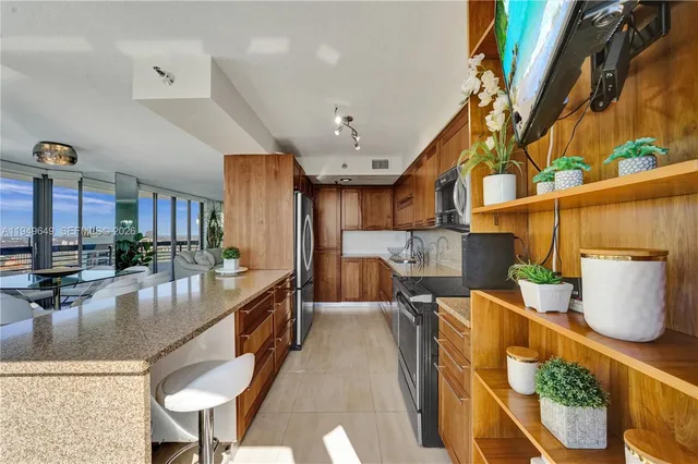 a bathroom with a granite countertop sink a toilet and shower