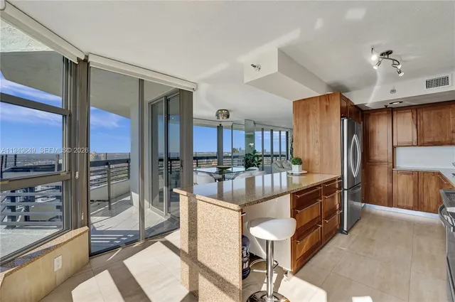 a living room with large window and furniture
