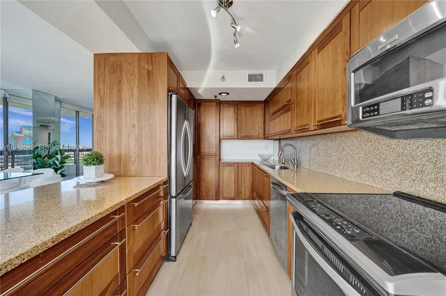 a bedroom with a large bed and a flat tv screen on dresser