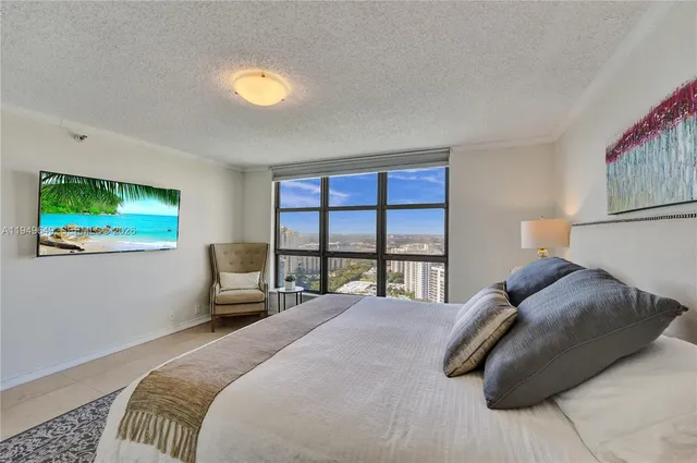 a living room with furniture and a floor to ceiling window