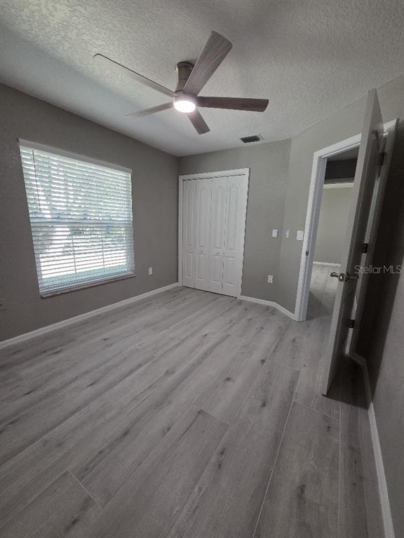 Undisclosed Address Spring Hill, FL 34609 - Photo 33 of 50 a view of an empty room with wooden floor and a window